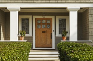 Greenery, doors and hardware make the entry way pop